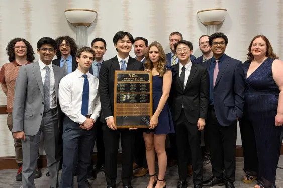 Representatives of the Michigan Debate Program holding an award for the Second Place National Ranking.