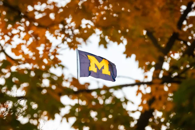 A navy University of Michigan flag with a large maize 