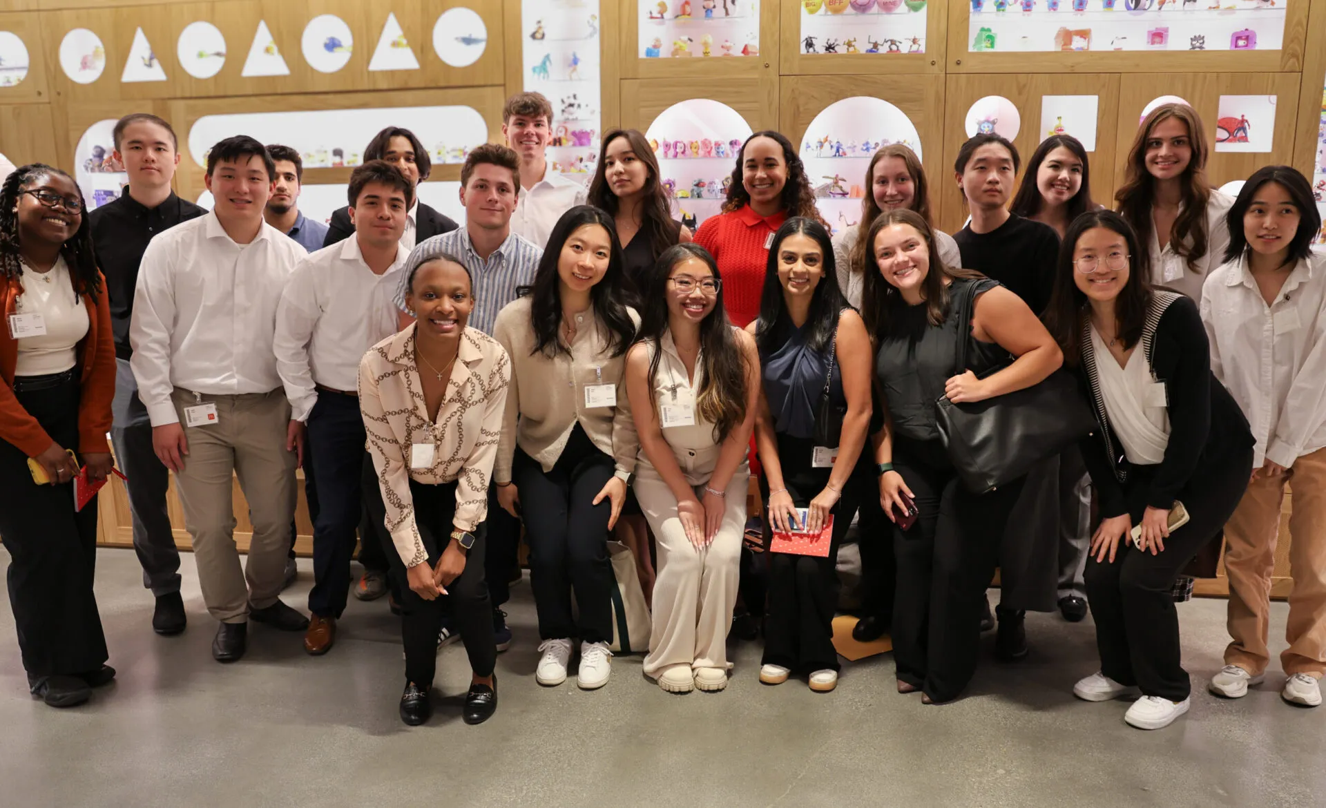 A large group of students gathered together. All are wearing professional clothing.