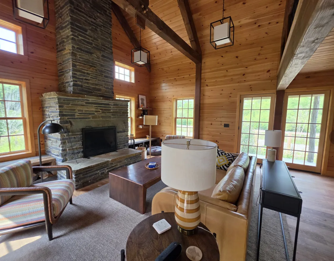 A large fireplace inside a cabin