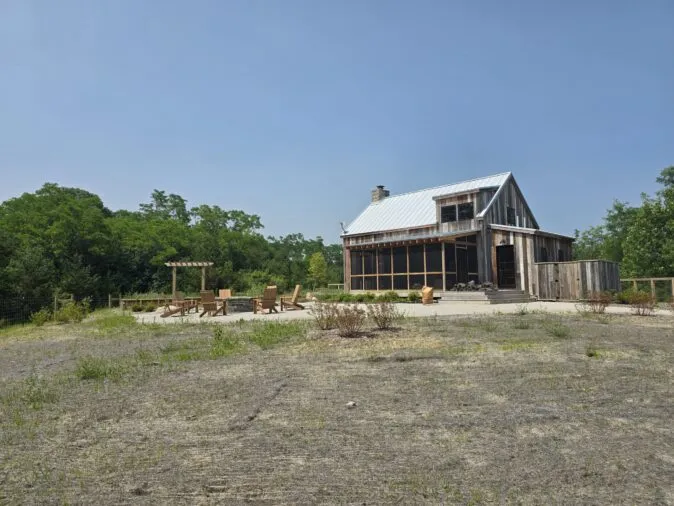A cabin with an outdoor gathering space.