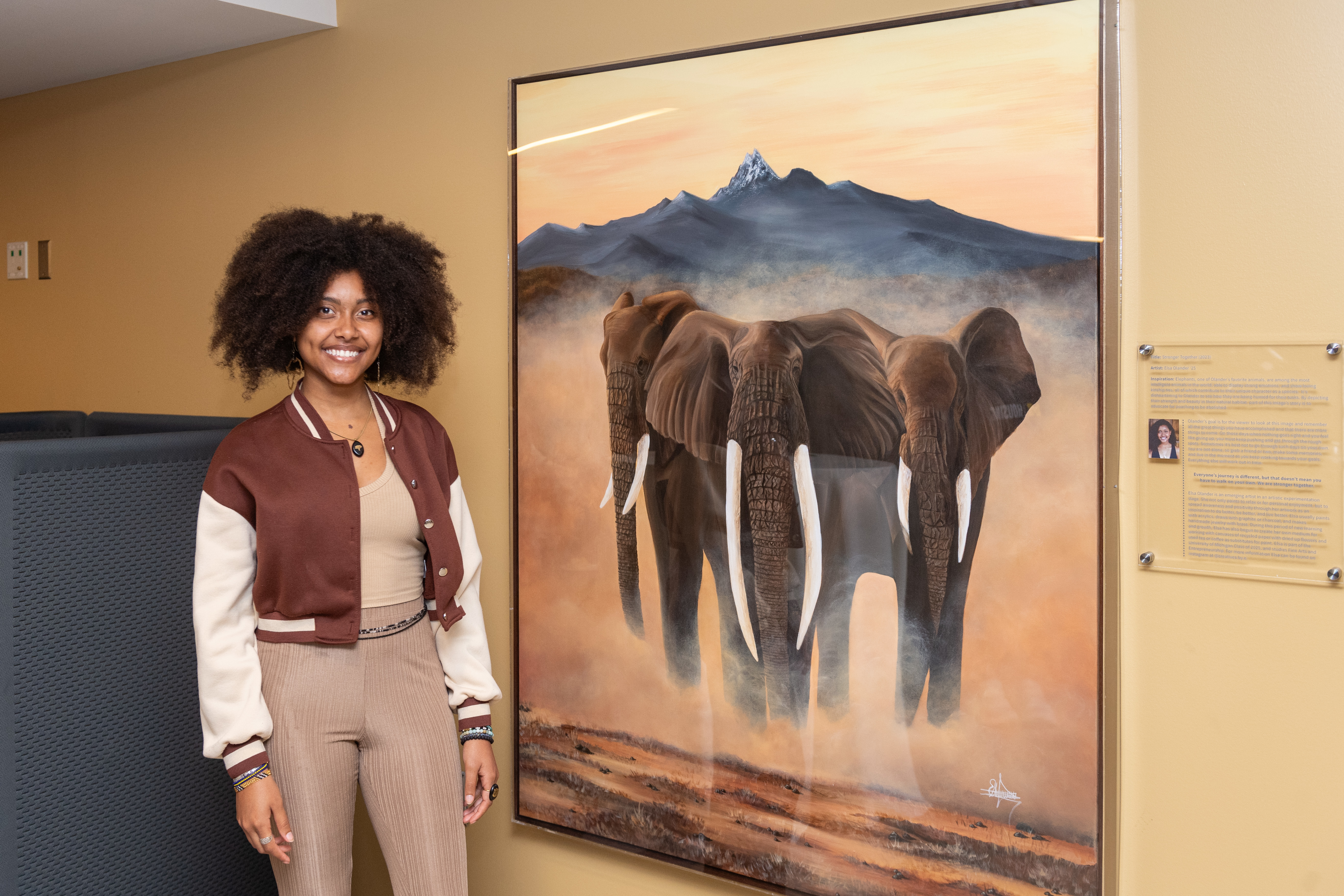 Elsa Olander with her painting of three elephants 