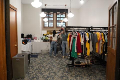 PBSL students setting up racks of clothing and other household items for the FreeStore.