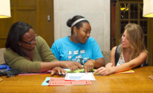 Three students work together on a project in the Michigan Union.