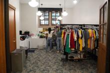 PBSL students setting up racks of clothing and other household items for the FreeStore.